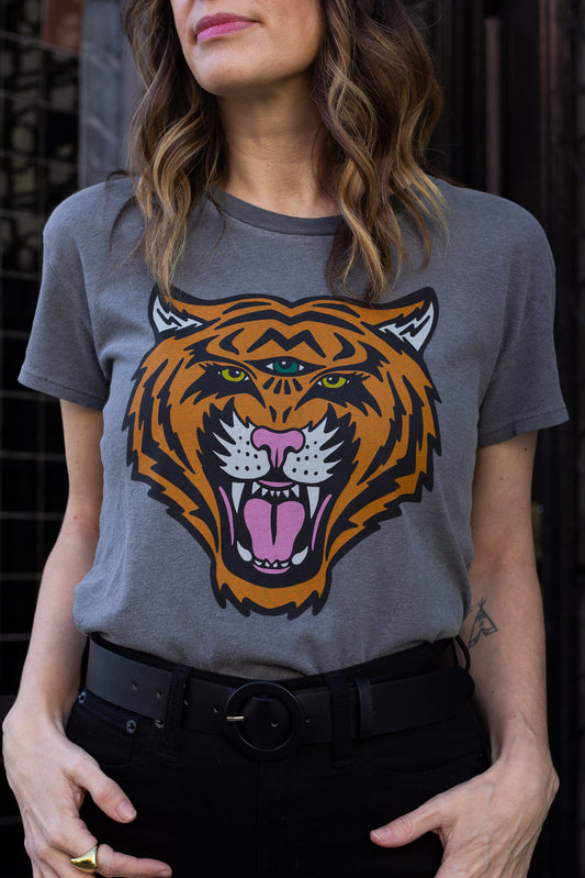Woman wearing a vintage black t-shirt with a tiger graphic design.