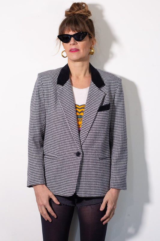 Person wearing a checkered blazer with a white background