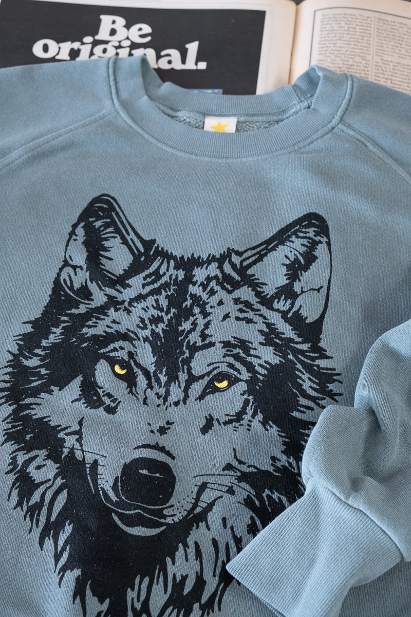Detail photograph of Thread Hippie green wolf sweatshirt.