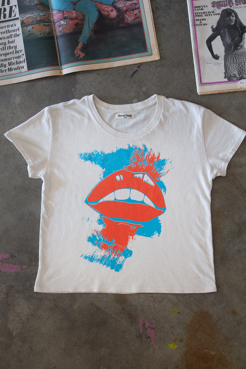 Flat lay of She Says graphic tee.