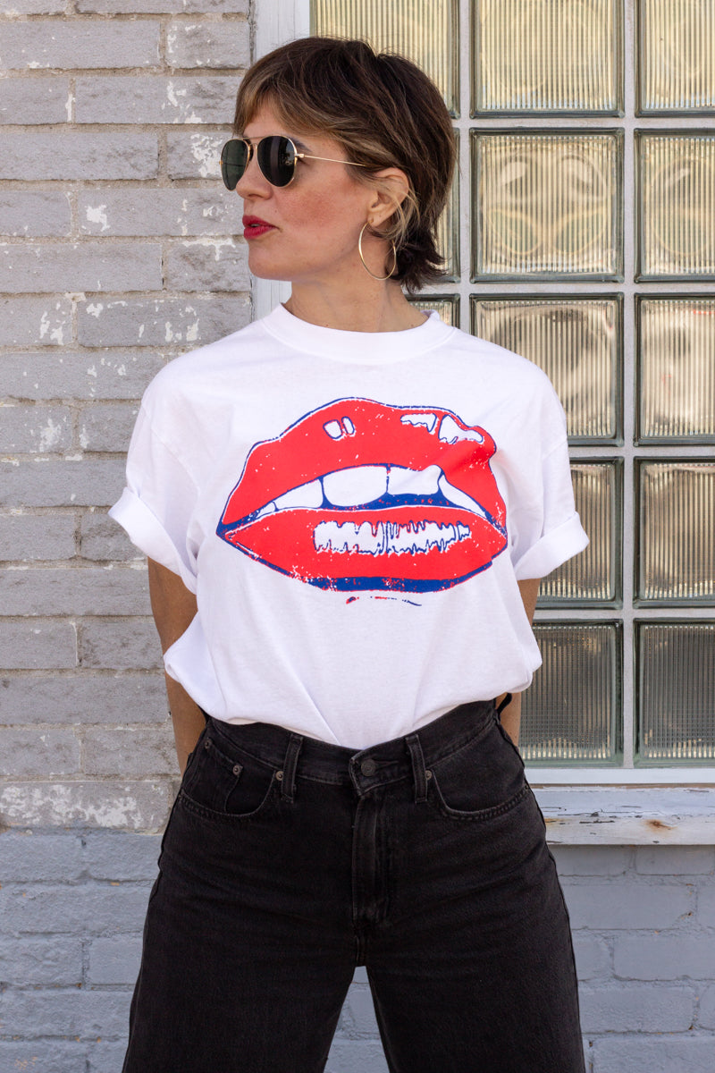 the "she says II" graphic tee on white