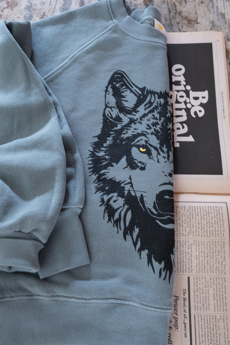 Thread Hippie CA detail shot of green wolf sweatshirt.