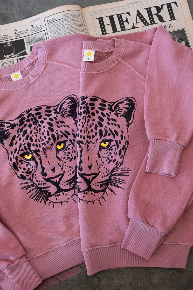 Thread Hippie women's sweatshirts stacked together on vintage rolling stone article.