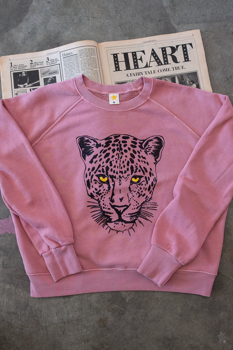 Detailed flat lay photo of women's pink sweatshirt.