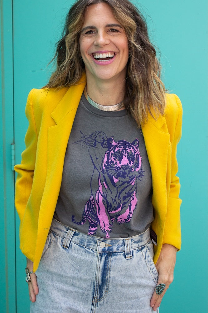 Angela wearing the Untamed women’s graphic t shirt on black and styled with yellow 80s blazer.