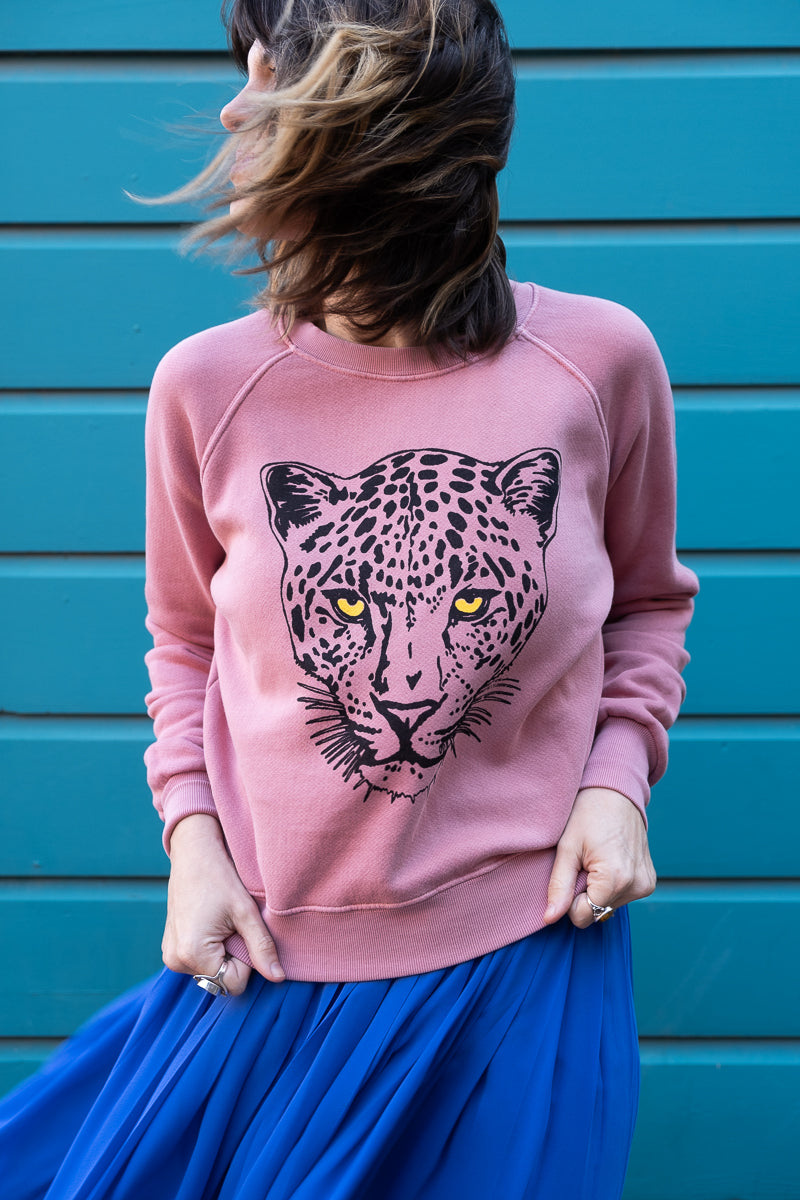 Thread Hippie women's pink snow leopard sweatshirt styled with blue skirt.