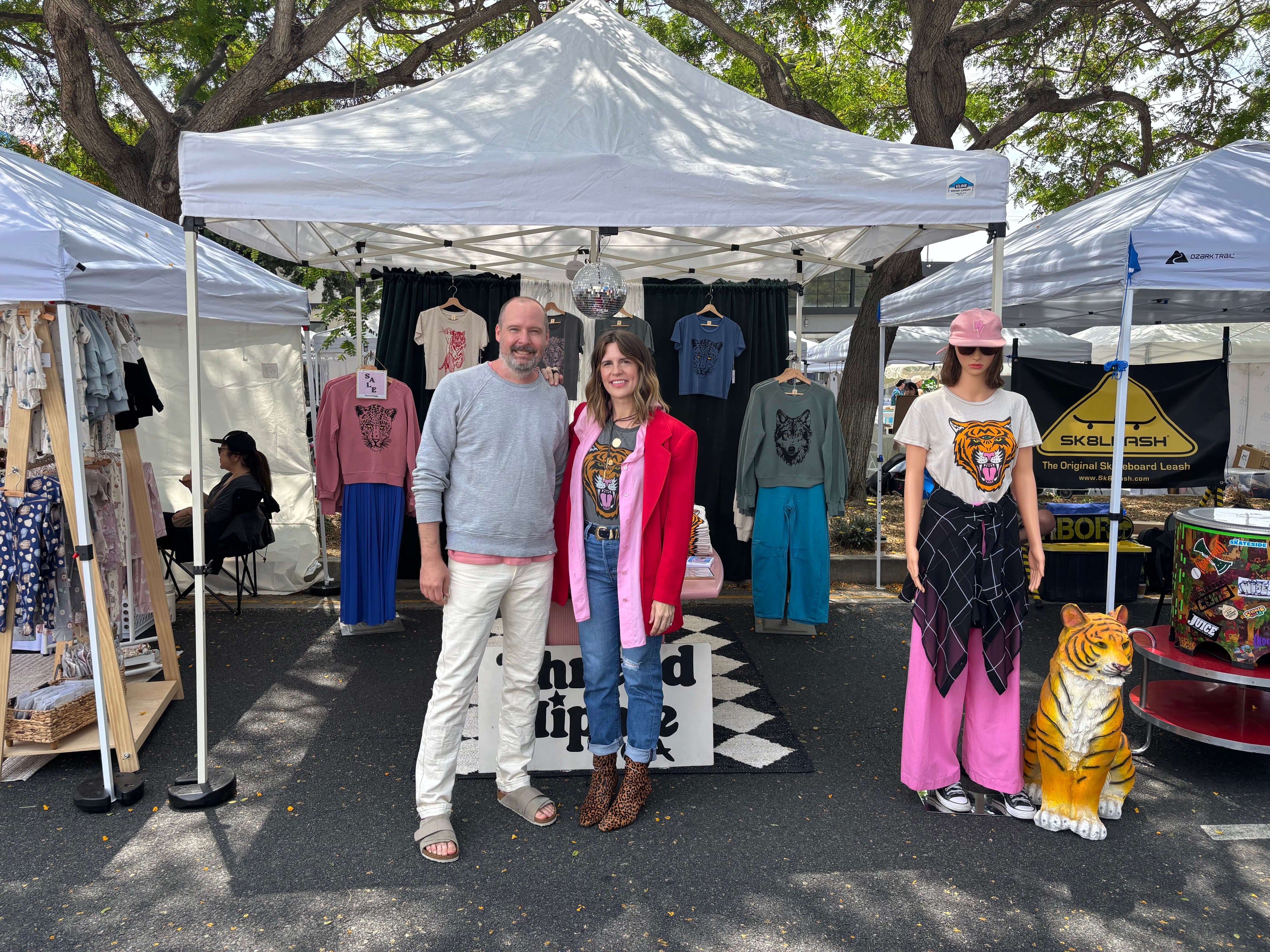 Thread Hippie founders at outdoor market.