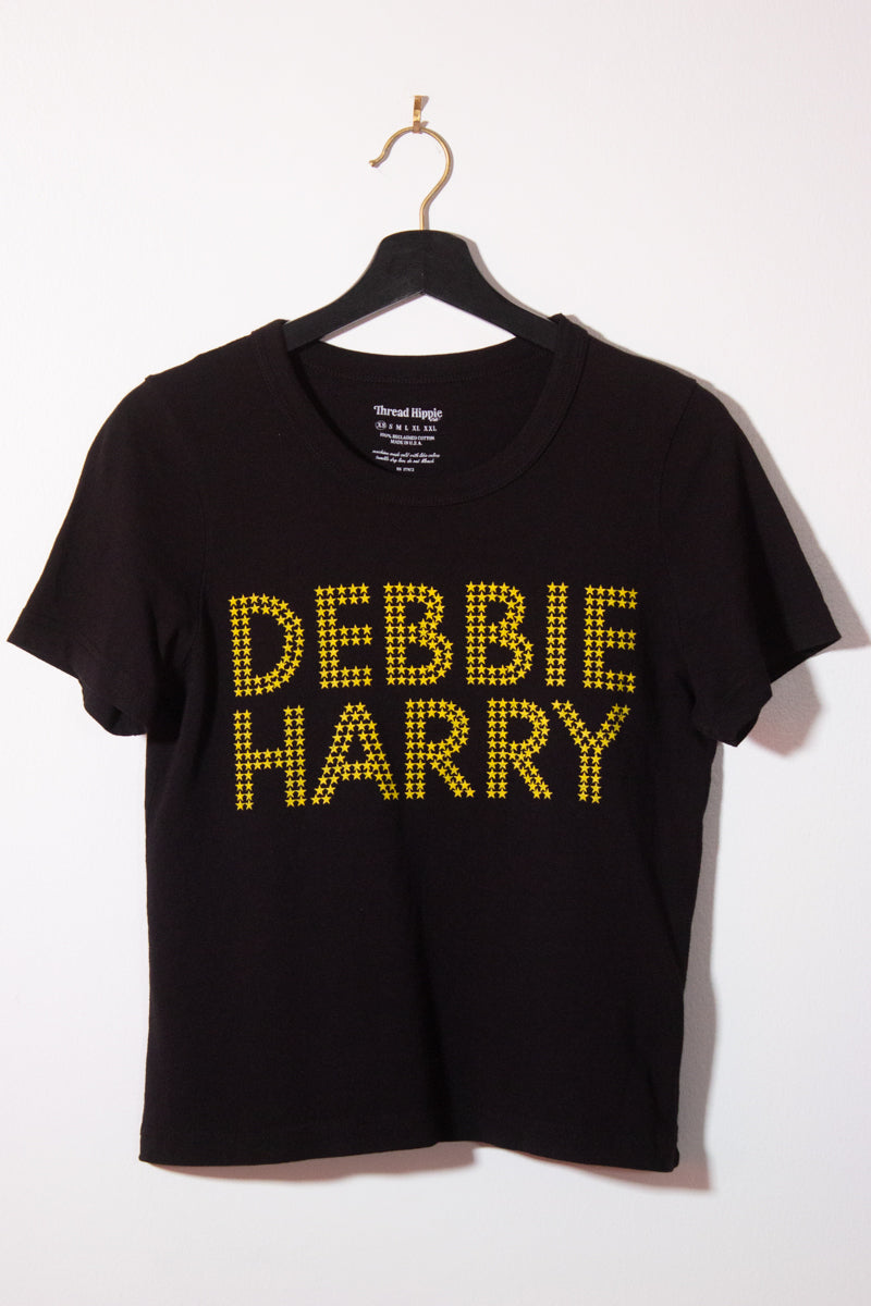 the "she's an icon" graphic tee on black