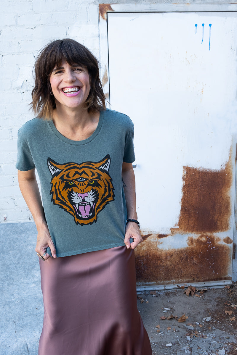 Women's Cosmic Tiger green boxy graphic tee styled on model - front view.