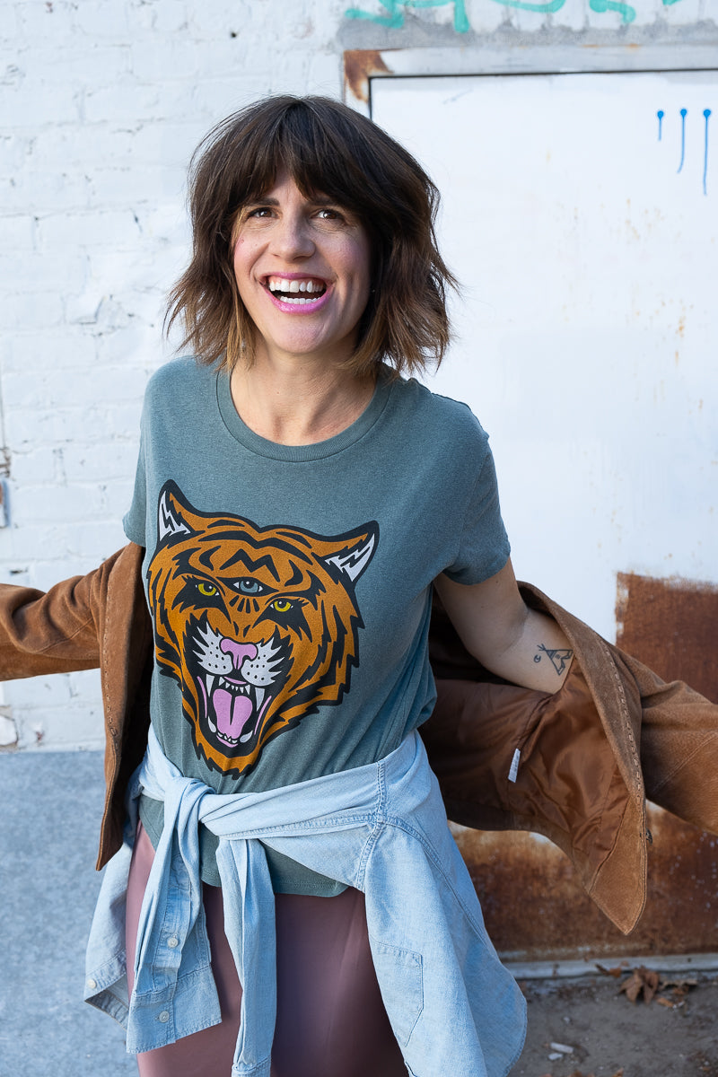 Women's Cosmic Tiger white boxy graphic tee styled on model with jacket.