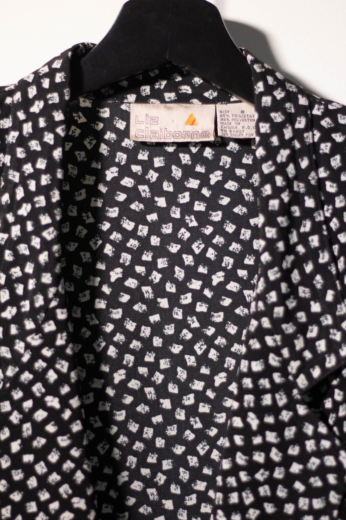 Black shirt with white pattern on a hanger