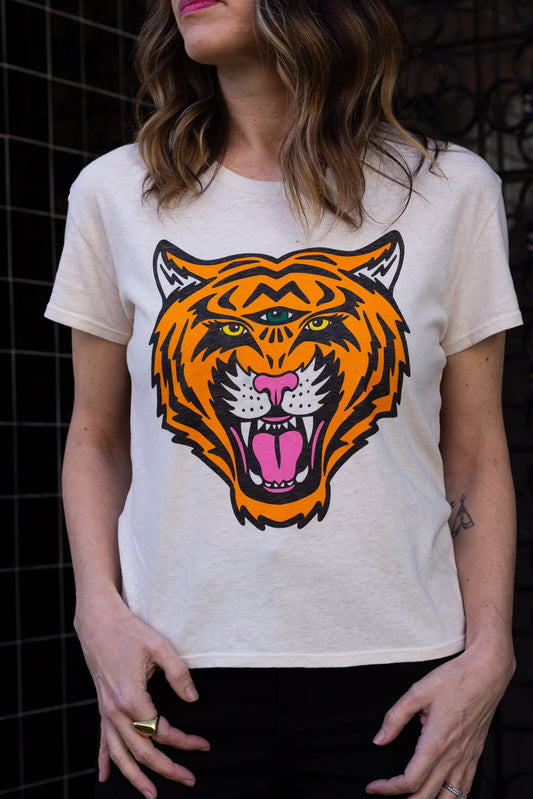 Woman wearing a white t-shirt with a colorful tiger graphic design.