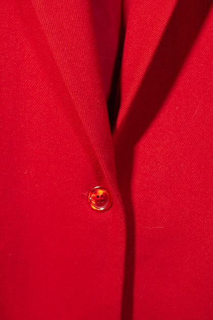 Close-up of a red button on a red fabric background
