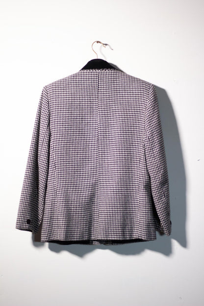 Checkered jacket on a hanger against a white background