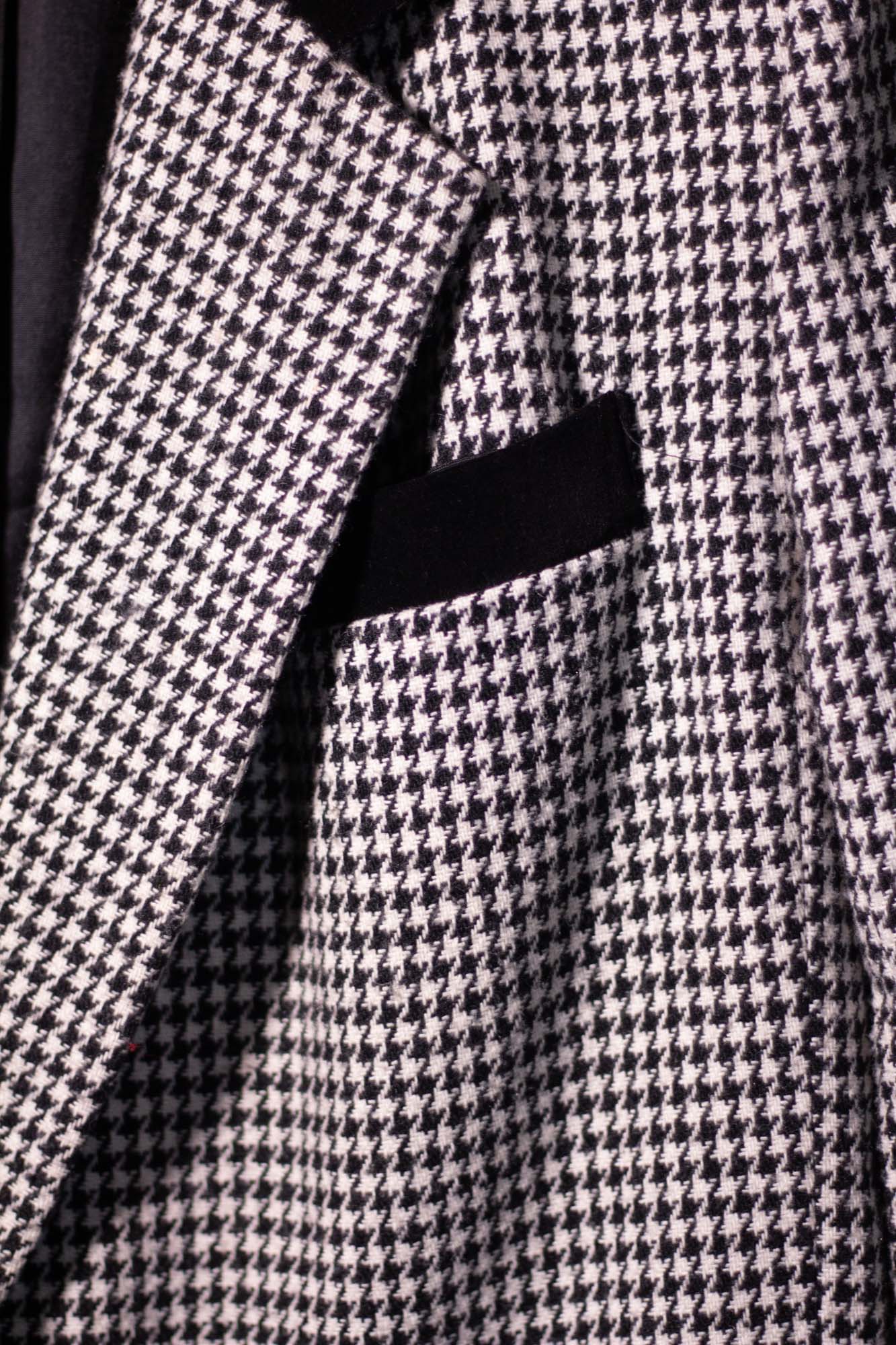 Close-up of a houndstooth patterned fabric with a black stripe.