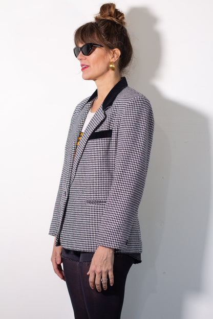 Woman wearing a checkered blazer against a white background