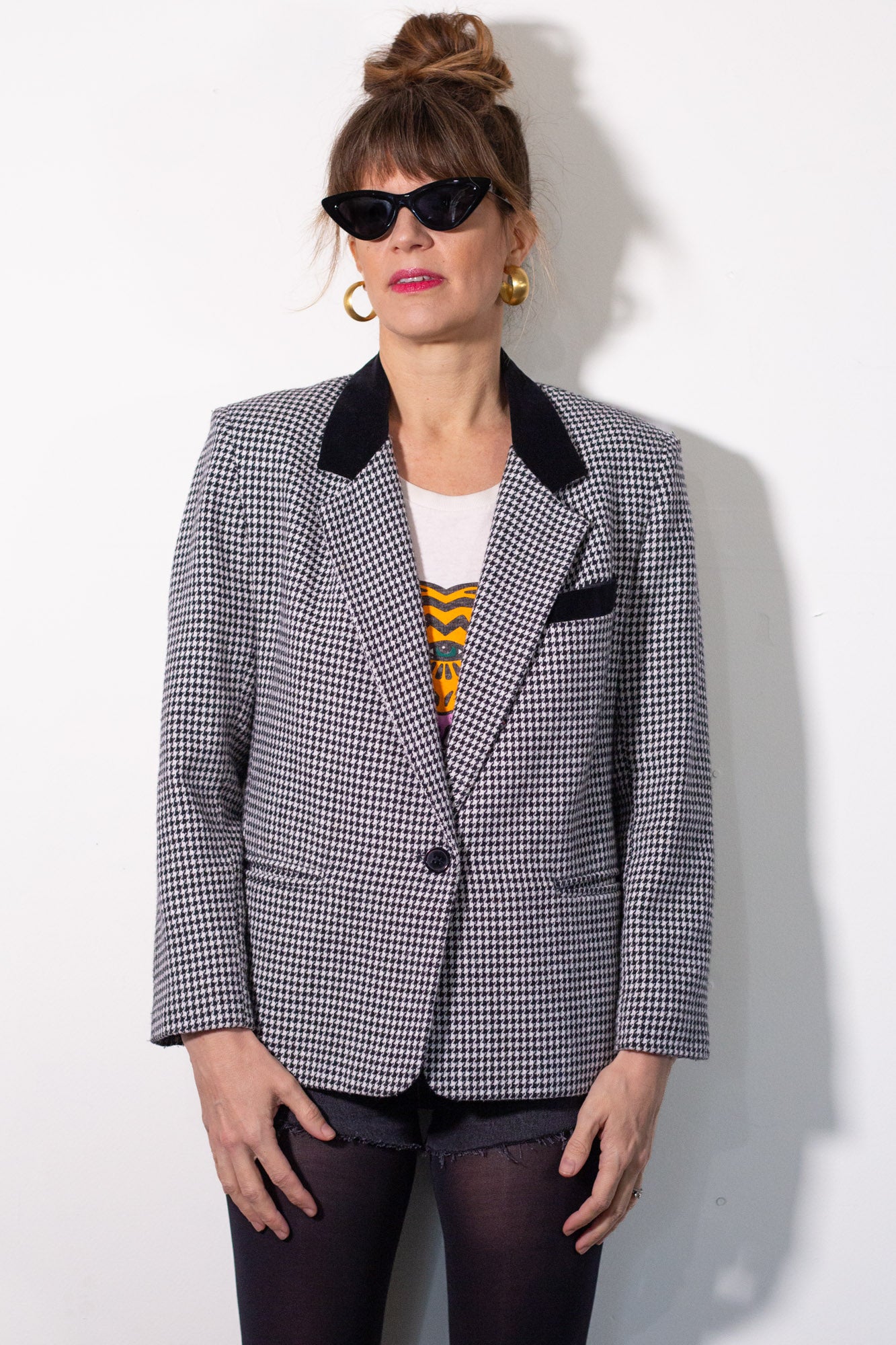 Person wearing a checkered blazer with a white background