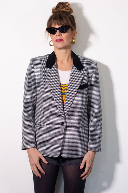 Person wearing a checkered blazer with a white background