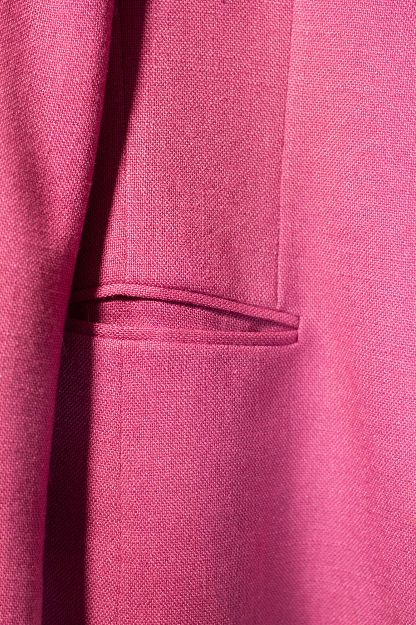 Close-up of a pink textured fabric with a pocket detail