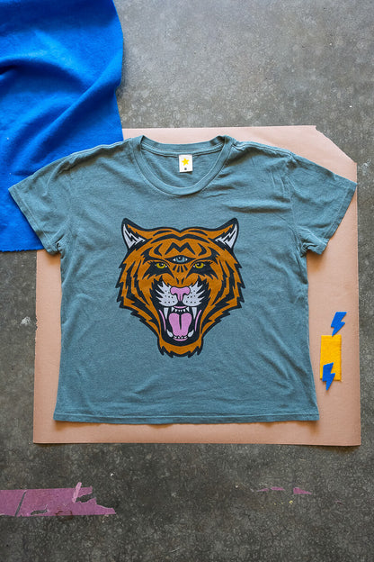 Green Thread Hippie Cosmic Tiger tee flat lay image.