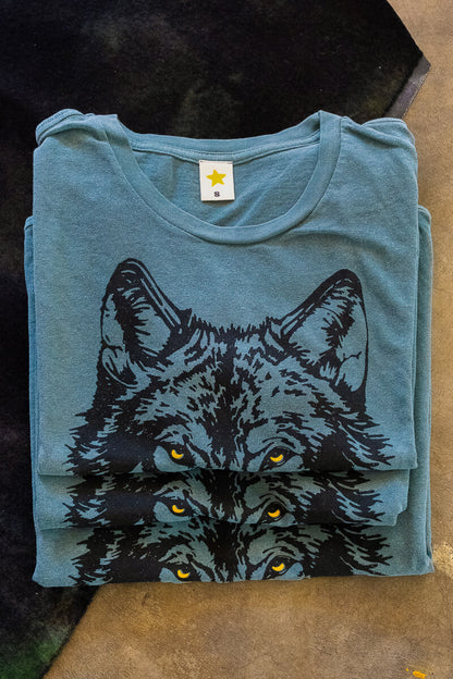 Folded green 80s graphic tee with a wolf graphic.