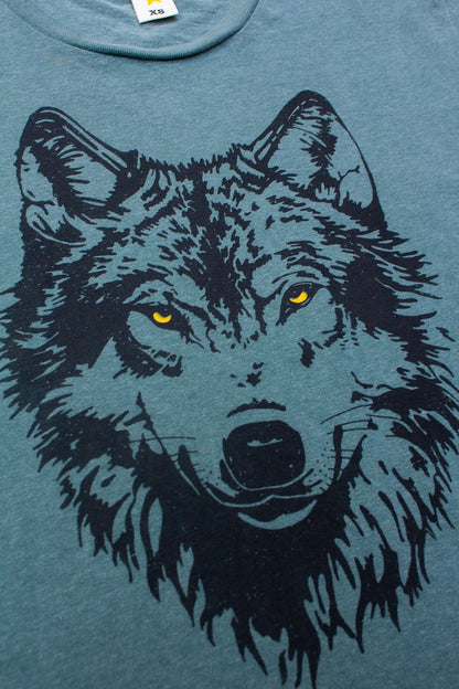 Women's green t-shirt with a black wolf graphic.