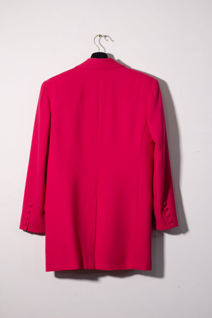 Pink blazer on a hanger against a white background