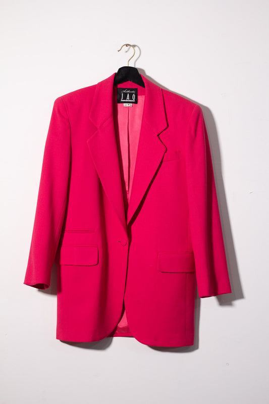 Bright pink blazer on a hanger against a white background