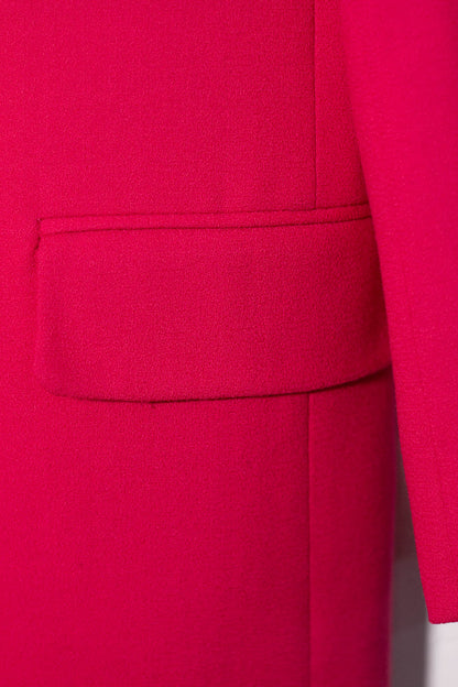 Close-up of a bright pink garment with a pocket detail.