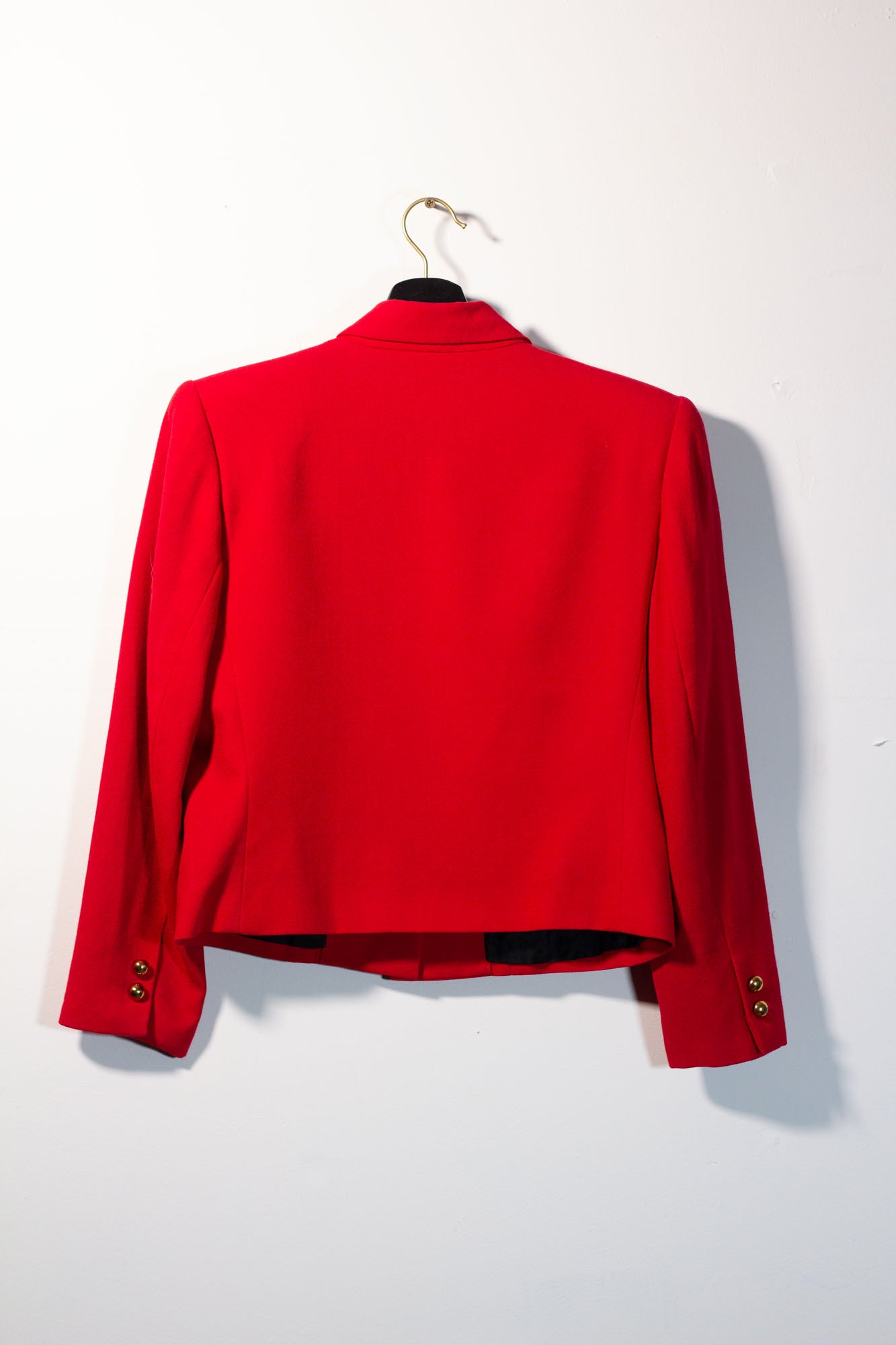Red jacket on a hanger against a white background