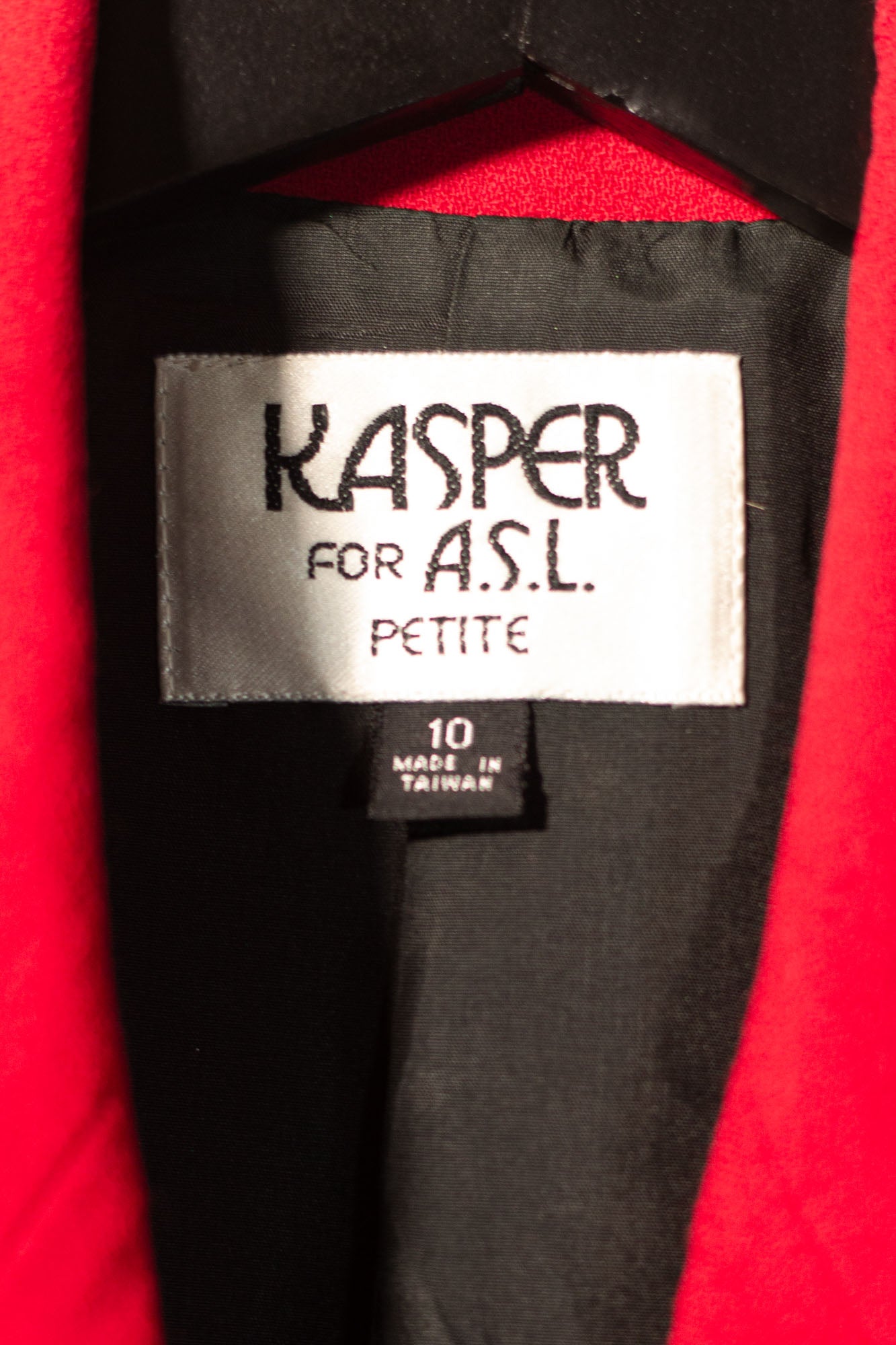 Label on a red garment with 'Kasper for A.S.L.' branding