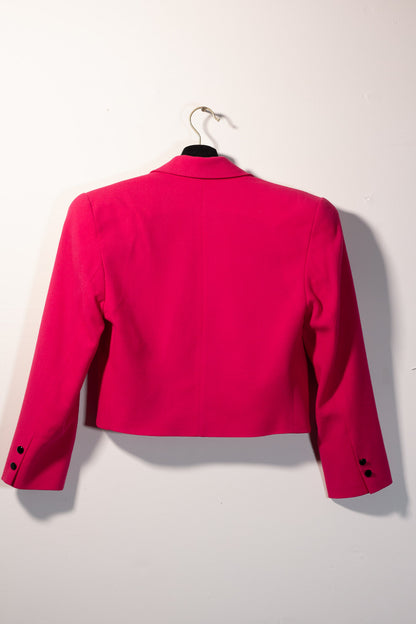 Pink jacket on a hanger against a white background
