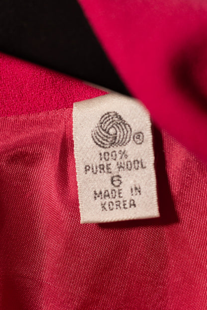 Label on red fabric indicating 100% pure wool and made in Korea