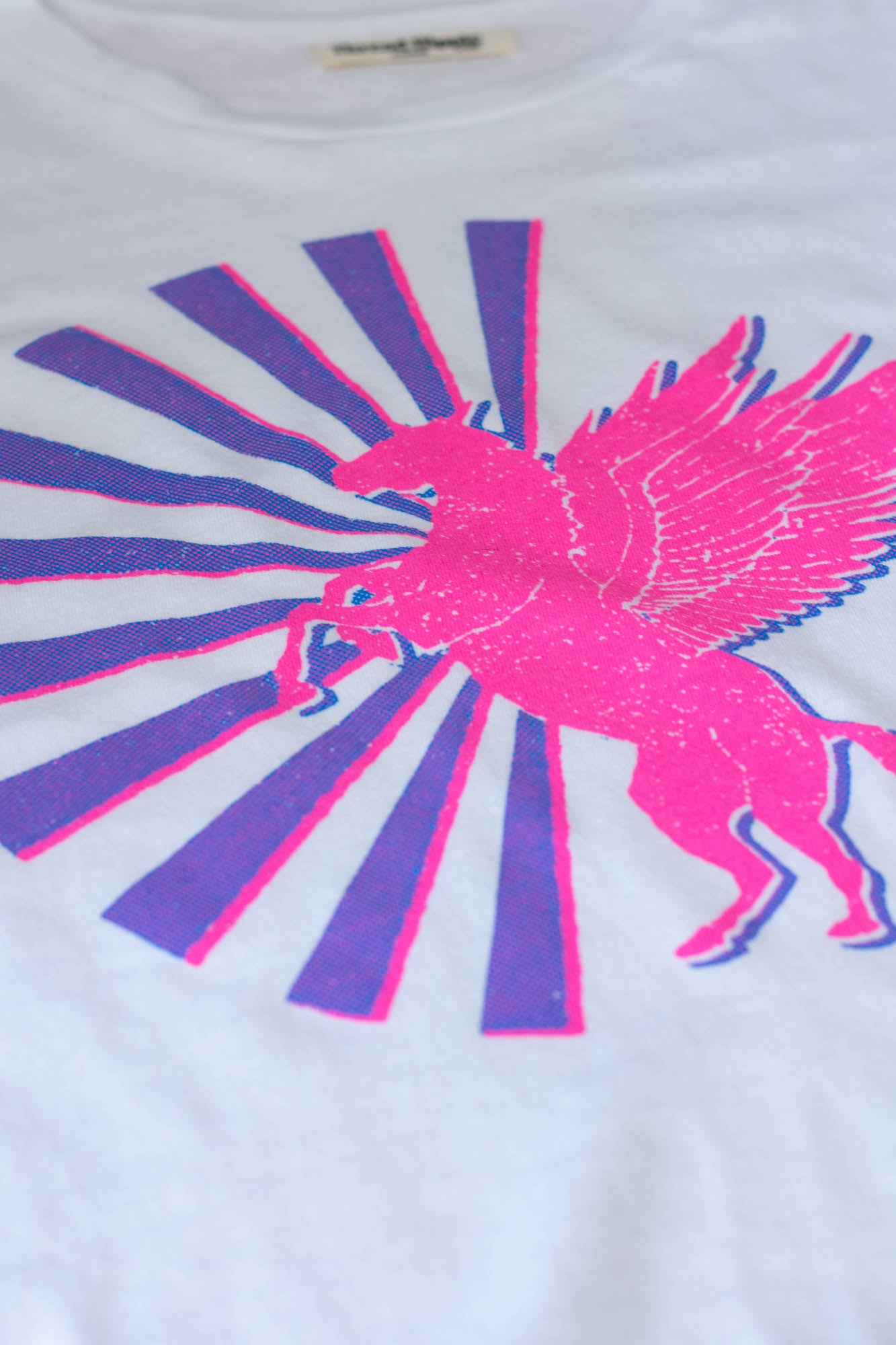 the "magic horse" graphic tee on white