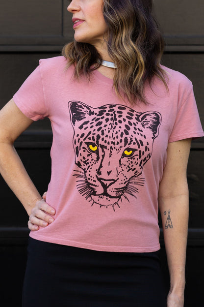 Woman wearing a pink t-shirt with a leopard graphic design.