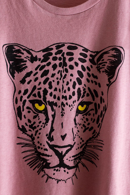 Pink t-shirt with a black leopard graphic on a plain background