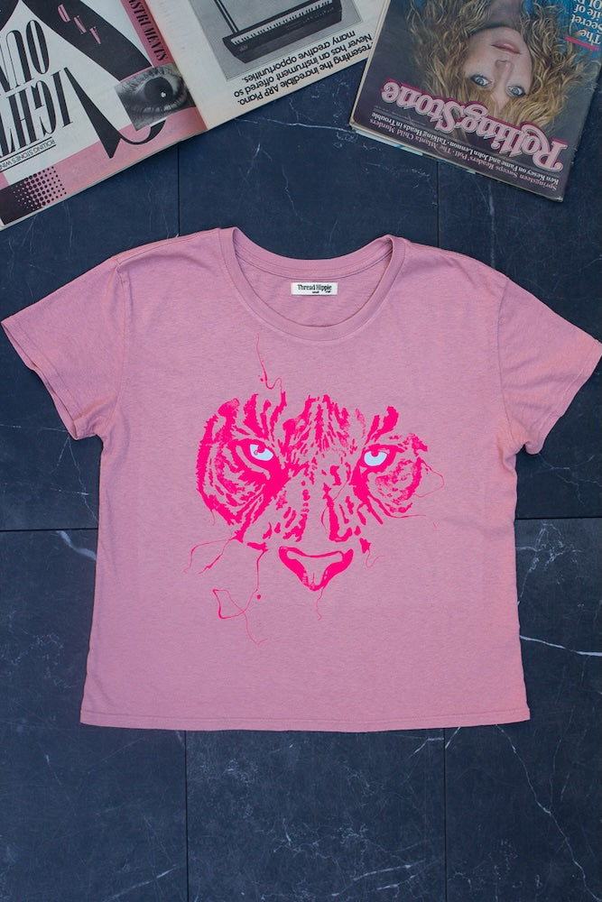 Tigress women’s graphic tee in pink, flat lay with bright pink and blue ink design.