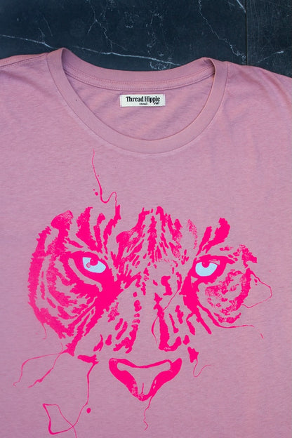 Detail photo of tiger eye graphic on pink women's t-shirt.