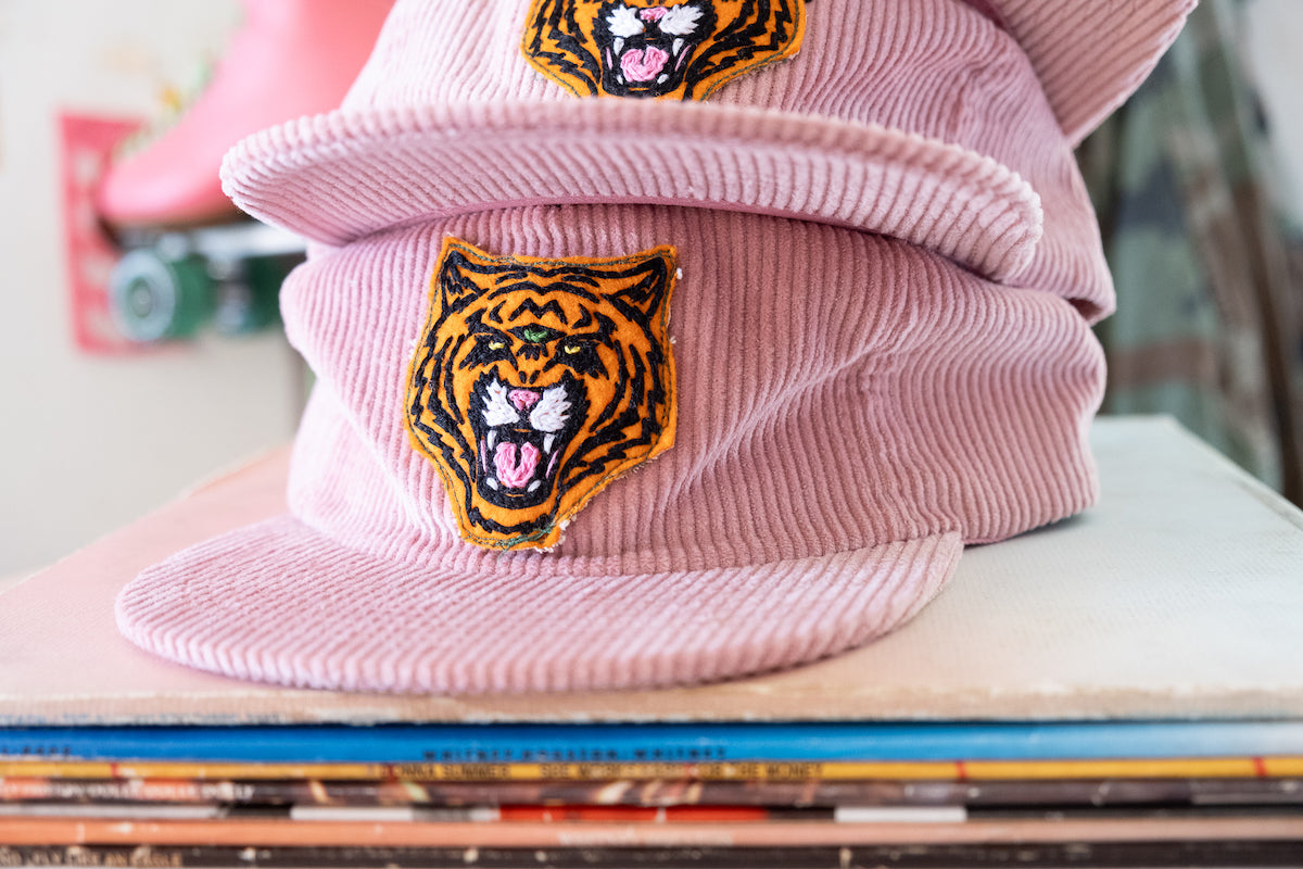 the "cosmic tiger" cap in pink cord