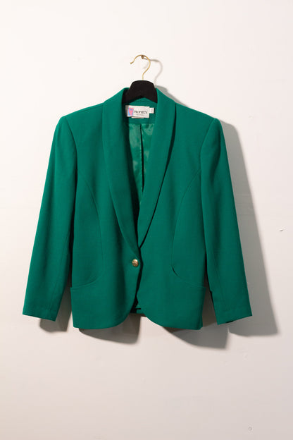 Green blazer on a hanger against a white background