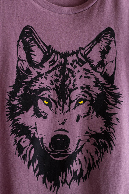 Purple t-shirt with a black wolf graphic on a plain background.