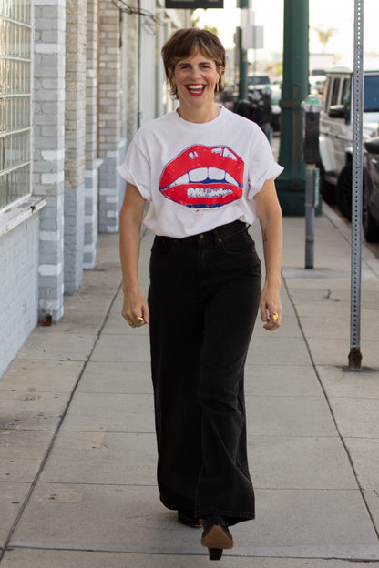 the "she says II" graphic tee on white