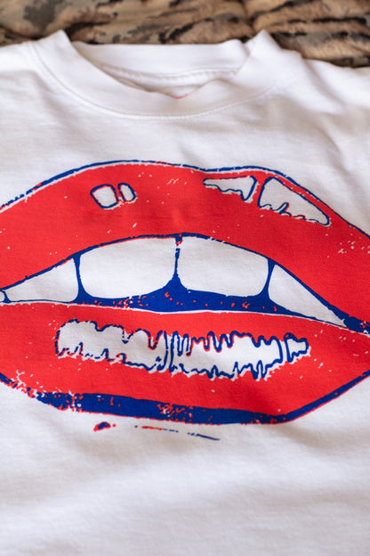 the "she says II" graphic tee on white
