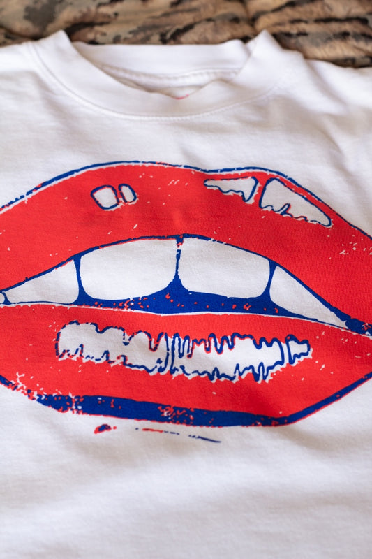 the "she says II" graphic tee on white