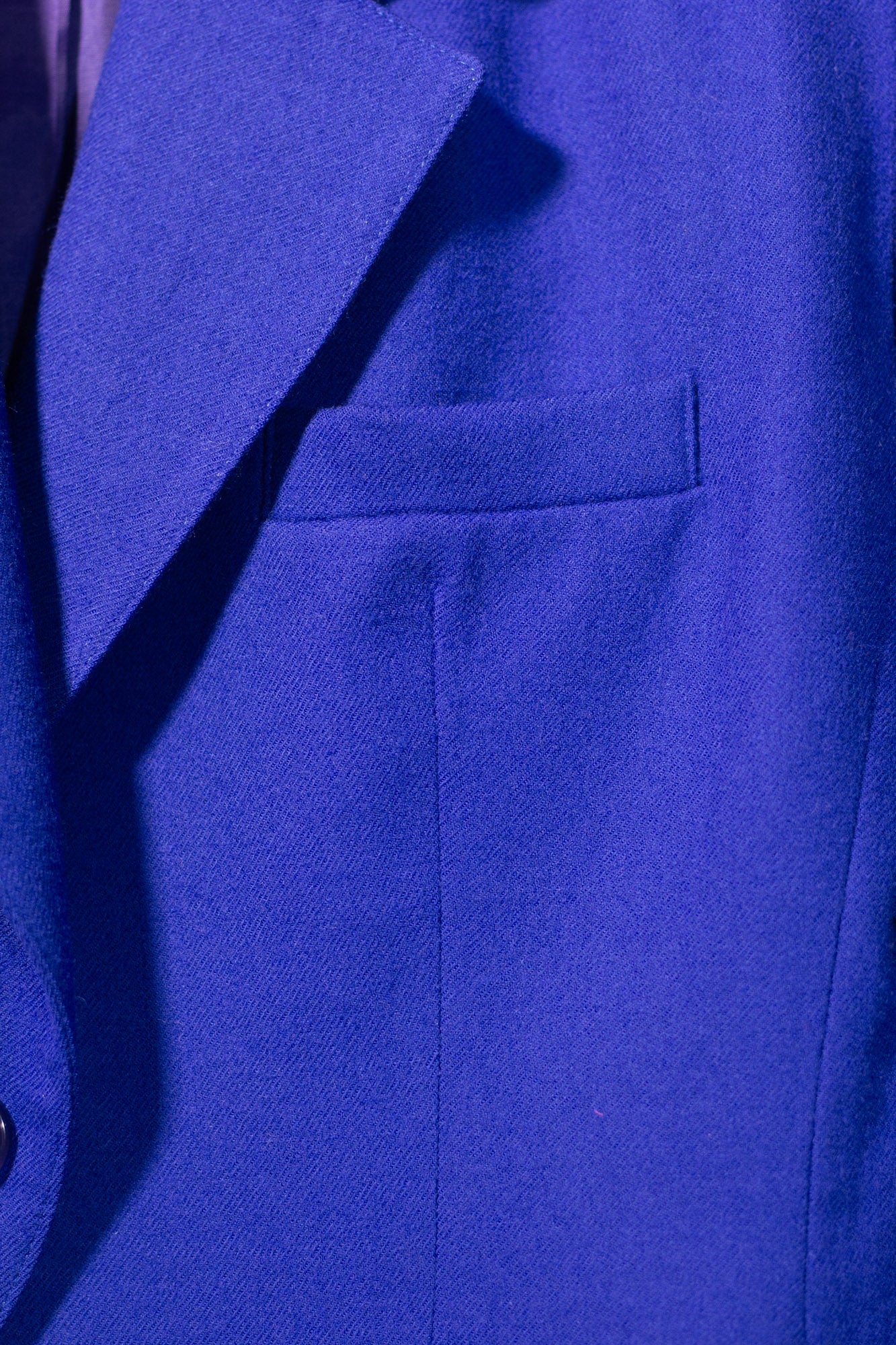 Close-up of a blue suit jacket with a pocket