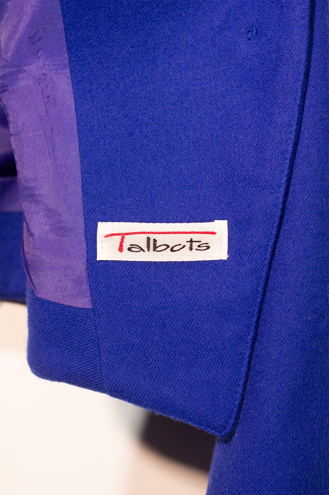 Blue jacket with a Talbots label on a white background