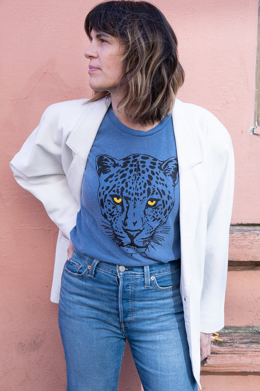 Women's Snow Leopard blue boxy graphic tee styled on model - front view.