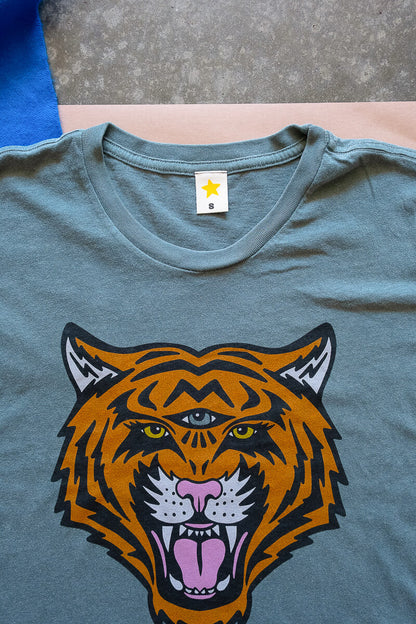 Green t-shirt with a tiger graphic on a neutral background.
