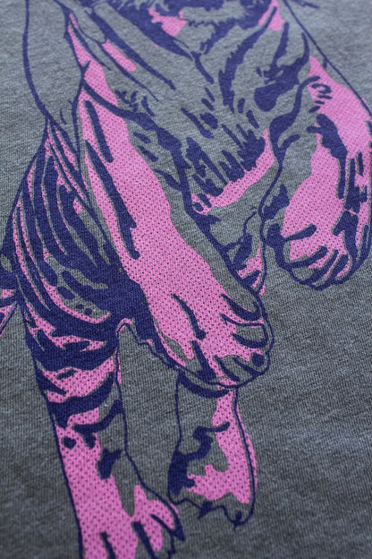 Details of the Untamed quality graphic tee in vintage black showing woman riding a tiger artwork.