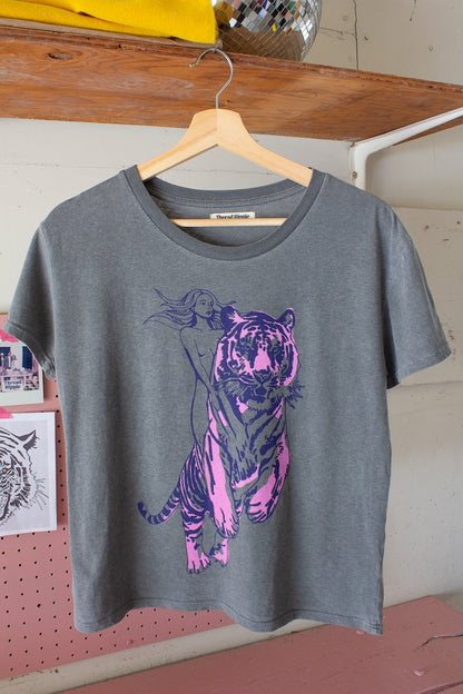 Untamed women’s graphic tee in vintage black with bold tiger rider design, front view.